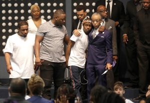 Rev. Al Sharpton, center right, hugs Stevante Clark during the funeral services for his brother, Stephon Clark, at Bayside Of South Sacramento Church on March 29, 2018. (Credit: Jeff Chiu-Pool/Getty Images)