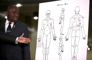 Attorney Ben Crump looks at a diagram showing gunshot wounds to Stephon Clark during a news conference in Sacramento on March 30, 2018. (Credit: Justin Sullivan / Getty Images)