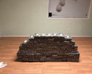 Rows of packaged cocaine are seen after being seized from an Inland Empire home where about $8.4 million in drugs was found following the arrests of two men, which authorities announced on March 23, 2018. (Credit: Orange County Sheriff's Department) 