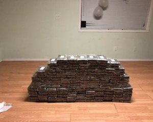 Rows of packaged cocaine are seen after being seized from an Inland Empire home where about $8.4 million in drugs was found following the arrests of two men, which authorities announced on March 23, 2018. (Credit: Orange County Sheriff's Department)