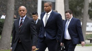 Jonathan Martin, center, walks with his attorney Winston McKesson, left, to be booked at the Los Angeles Police Department after pleading not guilty to making criminal threats at the Van Nuys Courthouse on March 20, 2018. (Credit: Gary Coronado / Los Angeles Times)