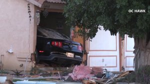 A woman died after a car crashed into her home in Moreno Valley on March 19, 2018. (Credit: OC Hawk)