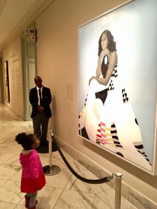 Parker Curry, 2, looks at a portrait of former first lady Michelle Obama at the National Portrait Gallery in Washington D.C. on March 1, 2018. (Credit: Ben Hines)