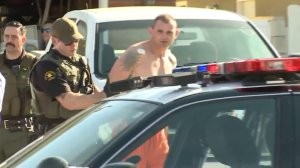 A man is seen being taken into custody after a pursuit extending from San Clemente to Santa Ana on March 6, 2018. (Credit: KTLA)