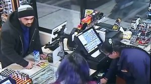 A man is shown in surveillance video released by the Santa Ana Police Department robbing a store on March 22, 2018.