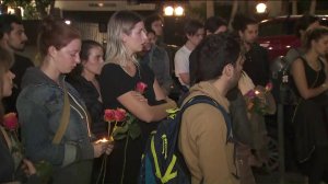 Loved ones of 25-year-old Adea Shabani stand outside her Hollywood apartment building on the evening of March 27, 2018, attending a vigil in her memory as her body was believed by LAPD to be found in a shallow grave in Northern California. (Credit: KTLA)