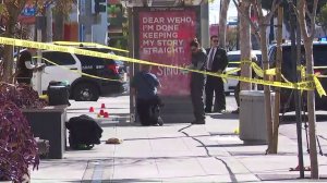 Investigators look through the scene in West Hollywood where a man was fatally stabbed on March 4, 2018. (Credit: KTLA)
