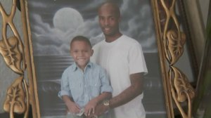 A photo of 28-year-old Devaughn Carter and his 8-year-old son is displayed on April 20, 2018. (Credit: KTLA)