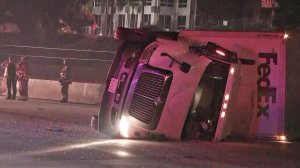 A big rig toppled on the 210 Freeway and blocked the nearby Metro tracks in Pasadena on April 26, 2018. (Credit: KTLA)