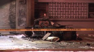 The charred body of a car is seen after it was involved in a fatal crash in Gardena on April 4, 2018. (Credit: KTLA)