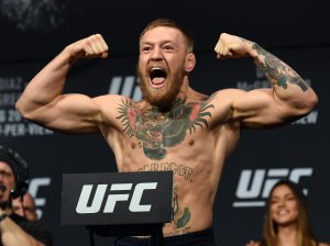 UFC featherweight champion Conor McGregor poses on the scale during his weigh-in for UFC 202 at MGM Grand Conference Center on Aug. 19, 2016, in Las Vegas. (Credit: Ethan Miller / Getty Images)