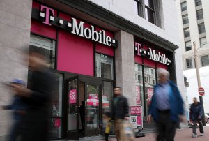 Pedestrians walk by a T-Mobile store in San Francisco on on April 24, 2017. (Credit: Justin Sullivan/Getty Images)