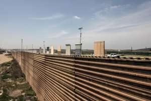 A U.S. border patrol truck is seen next to US President Donald Trump's border wall prototypes from the US-Mexico border in Tijuana on April 3, 2018.(Credit: GUILLERMO ARIAS/AFP/Getty Images)