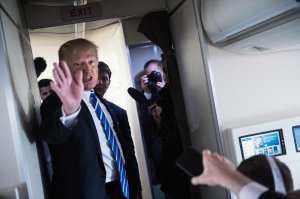 President Donald Trump speaks to reporters on board Air Force One as he travels back to Washington, DC, on April 5, 2018. (Credit: Nicholas Kamm / AFP / Getty Images)