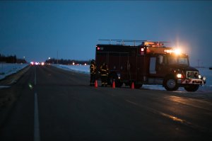 An emergency vehicle is seen near the crash site on April 6, 2018, after a bus carrying a junior ice hockey team collided with a semi-trailer truck between Tisdale and Nipawin, Saskatchewan province, killing 15 people. (Credit: Kymber Rae / AFP / Getty Images)