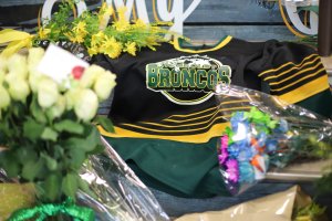 An ice hockey jersey is left in a makeshift memorial at the Humboldt Uniplex in Humboldt, Canada, on April 8, 2018. (Credit: KYMBER RAE/AFP/Getty Images)