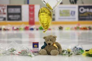 Flowers, cards and sentimental gifts adorn the ice surface at Humboldt Uniplex during preparations for a prayer vigil for the Humboldt Broncos ice hockey team, April 8, 2018 in Humboldt, Canada. (Credit: KYMBER RAE/AFP/Getty Images)