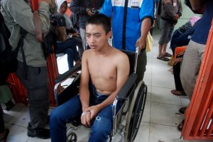 An Indonesian man is taken to a hospital in Bandung, West Java province, for treatment after drinking illegal alcohol on April 9, 2018. (Credit: Timur Matahari / AFP / Getty Images)
