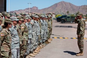 Members of the Arizona National Guard listen to instructions on April 9, 2018, at the Papago Park Military Reservation in Phoenix. (Credit: Caitlin O'Hara / AFP / Getty Images)