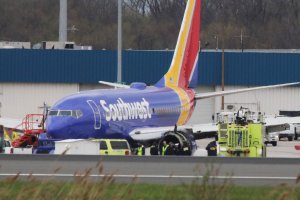 A Southwest Airlines jet sits on the runway at Philadelphia International Airport after it was forced to land with an engine failure, in Philadelphia, Pennsylvania, on April 17, 2018. (Credit: DOMINICK REUTER/AFP/Getty Images)