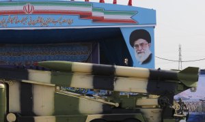 An Iranian military truck carries missiles past a portrait of Iran's Supreme Leader Ayatollah Ali Khamenei during a parade on the occasion of the country's annual army day on April 18, 2018 in Tehran. (Credit: ATTA KENARE/AFP/Getty Images)