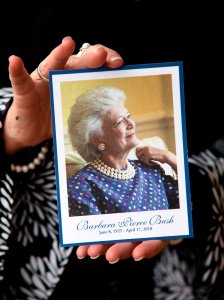 An attendant at Second Baptist Church holds a memorial card she was given after viewing former First Lady Barbara Bush's casket lying in repose at St. Martin's Episcopal Church in Houston, Texas on April 20, 2018. (Credit: DANIEL KRAMER/AFP/Getty Images)