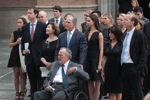 Former president George H.W. Bush and son, former president George W. Bush, watch with family as the coffin of former first lady Barbara Bush is placed in a hearse outside of St. Martin's Episcopal Church following her funeral service on April 21, 2018 in Houston, Texas. (Credit: Scott Olson/Getty Images)