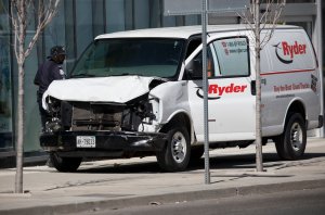 Police inspect a van suspected of being involved in a crash that injured multiple pedestrians on April 23, 2018 in Toronto, Canada. (Credit: Cole Burston/Getty Images)