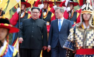 North Korea's leader Kim Jong Un, left, walks with South Korea's President Moon Jae-in during a welcoming ceremony ahead of their meeting at Panmunjom on April 27, 2018. (Credit: Korea Summit Press Pool / AFP / Getty Images)