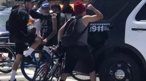 Participants at a South L.A. vigil for Frederick Frazier, a cyclist killed in a hit-and-run, target an LAPD patrol vehicle on April 11, 2018. (Credit: KTLA)