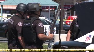 SWAT officers with Anaheim police help search for a man wanted on suspicion of assaulting an officer on April 17, 2018. (Credit: KTLA)