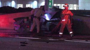 Authorities investigate the scene of a fatal crash on the 10 Freeway in Pomona on April 7, 2018. (Credit: OnScene.TV)