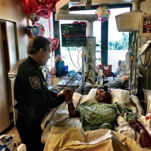 Sheriff Scott Israel holds the hand of Anthony Borge, a student who shot five times in the massacre. (Credit: Broward County Sheriff's Office)