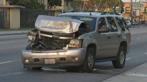 A gold SUV with a damaged front end is seen at the site of a crash in Watts on April 13, 2018, that left four people in critical condition. (Credit: KTLA)