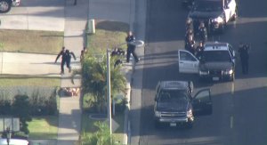 A man suspected of intentionally ramming a police vehicle in Santa Ana surrenders to police on May 17, 2018. (Credit: KTLA)