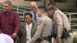 CHP officers reunite with the Lopez family on May 18, 2018. (Credit: KTLA)