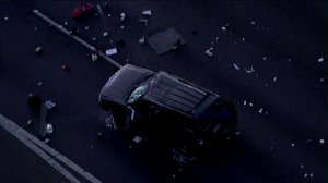 An SUV is surrounded by debris after it was involved in a crash with a California Highway Patrol officer on the 101 Freeway in Camarillo, May 10, 2018. (Credit: KTLA)