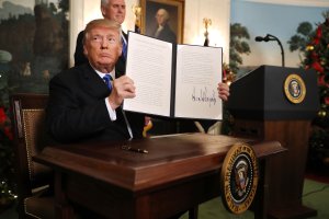 U.S. President Donald Trump holds up a proclamation that the U.S. government will formally recognize Jerusalem as the capital of Israel after signing the document in the Diplomatic Reception Room at the White House on December 6, 2017, in Washington, D.C. (Credit: Chip Somodevilla/Getty Images)