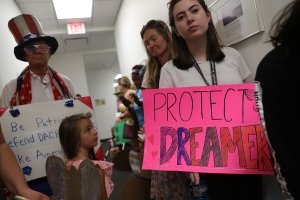 Lily Logsdon, right, joins other activists in front of the office of Sen. Bill Nelson, D-Fl, to ask him to help recipients of the Deferred Action for Childhood Arrivals on Feb. 2, 2018 in West Palm Beach, Florida. (Credit: Joe Raedle/Getty Images)