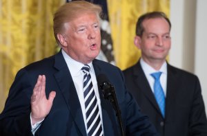 US President Donald Trump speaks alongside Secretary of Labor Alexander Acosta (R) during the National Teacher of the Year reception in the East Room of the White House in Washington, DC, May 2, 2018. (Credit: SAUL LOEB/AFP/Getty Images)