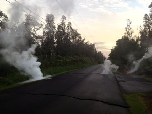 In this handout photo provided by the U.S. Geological Survey, a fissure produces steam from a street after the eruption of Hawaii's Kilauea volcano on May 4, 2018, in the Leilani Estates subdivision near Pahoa.