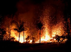 In this handout photo provided by the U.S. Geological Survey, lava erupts from a new fissure from Luana Street after the eruption of Hawaii's Kilauea volcano on May 5, 2018 in the Leilani Estates subdivision near Pahoa, Hawaii. (Credit: U.S. Geological Survey via Getty Images)