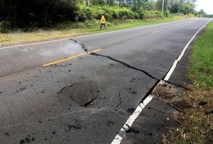 In this handout photo provided by the U.S. Geological Survey, a crack opened on Pohoiki Road just east of Leilani Street after the eruption of Hawaii's Kilauea volcano on May 5, 2018 in the Leilani Estates subdivision near Pahoa, Hawaii. (Credit: U.S. Geological Survey via Getty Images)