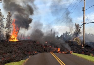 In this handout photo provided by the U.S. Geological Survey, lava from a fissure slowly advances to the northeast on Hookapu Street after the eruption of Hawaii's Kilauea volcano on May 5, 2018 in the Leilani Estates subdivision near Pahoa, Hawaii. (Credit: U.S. Geological Survey via Getty Images)