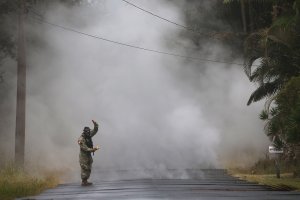 U.S. Army National Guard First Lt. Aaron Hew Len takes measurements for sulfur dioxide gas at volcanic fissures in the Leilani Estates neighborhood in the aftermath of eruptions from the Kilauea volcano on Hawaii's Big Island on May 8, 2018 in Pahoa, Hawaii. (Credit: Mario Tama/Getty Images)