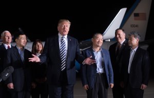 President Donald Trump gestures as he speaks upon the return of U.S. detainees Tony Kim (front Left), Kim Hak-song (right) and Kim Dong-chul (3rd right) after they were released by North Korea, at Joint Base Andrews in Maryland on May 10, 2018. (Credit: Saul Loeb/AFP/Getty Images)
