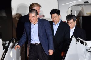 US President Donald Trump (back L) welcomes the arrival of US detainees Kim Dong-chul (L), Kim Hak-song (R) and Tony Kim (2nd R) after they were released by North Korea, at Joint Base Andrews in Maryland on May 10, 2018. (Credit: NICHOLAS KAMM/AFP/Getty Images)