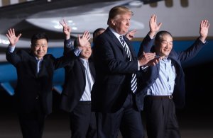 US President Donald Trump (2nd R) walks with US detainees Tony Kim (L), Kim Hak-song (2nd L) and Kim Dong-chul (R) upon their return after they were released by North Korea, at Joint Base Andrews in Maryland on May 10, 2018. (Credit: SAUL LOEB/AFP/Getty Images)