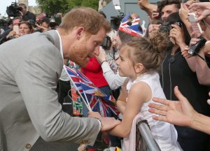 Prince Harry greets members of the public as he embarks on a walkabout ahead of his wedding to Meghan Markle, May 18, 2018 in Windsor, England. (Credit: Ben Birchall / Getty Images)