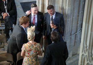 : David and Victoria Beckham (right) talk with Sir Elton John and David Furnish (left) and Sofia Wellesley and James Blunt (foreground) as they arrive in St George's Chapel at Windsor Castle for the wedding of Prince Harry to Meghan Markle on May 19, 2018 in Windsor, England. (Credit: Danny Lawson - WPA Pool/Getty Images)